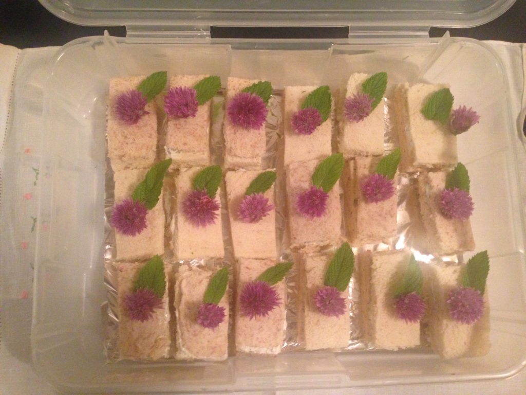 The finished produc - Finger sandwiches, Garnished with onion flowers and mint.