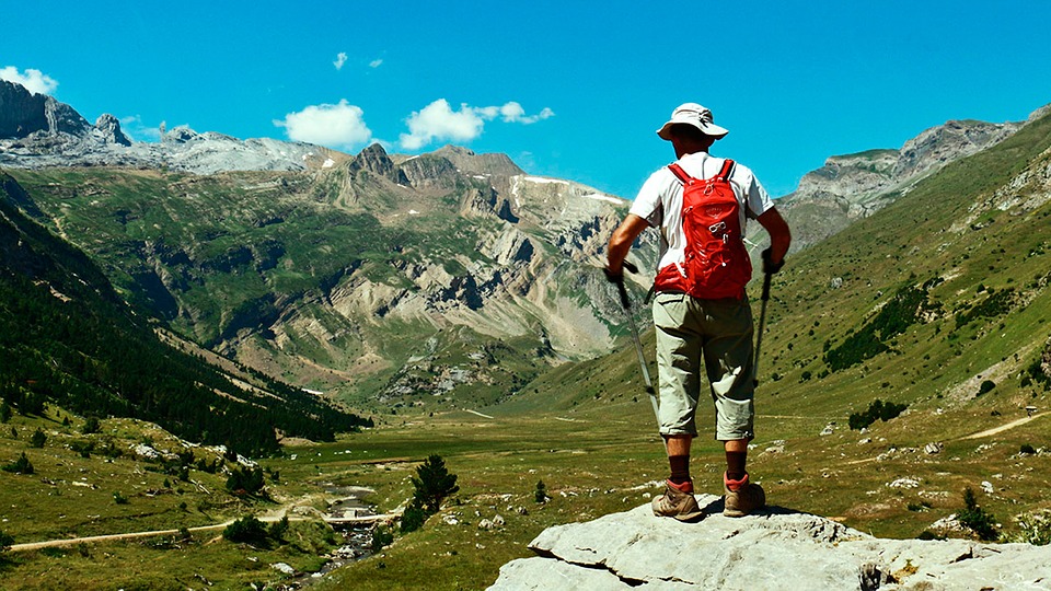 Man standing on mountain enjoying vista
